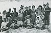 Men and women pose on summit of Mt. Hood, July 1896. Pitch was applied to climbers' faces as sunscreen.